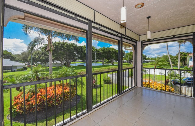 unfurnished sunroom with a water view