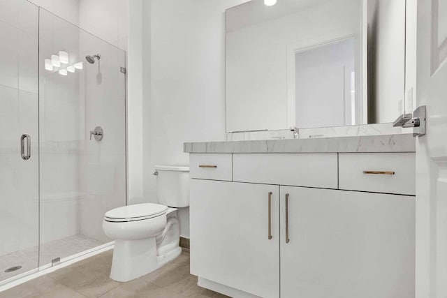 bathroom featuring vanity, tile patterned flooring, toilet, and walk in shower