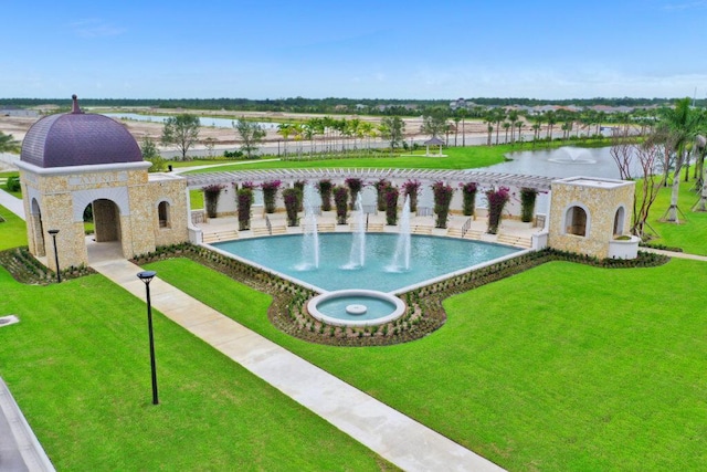 view of swimming pool featuring a water view and a yard