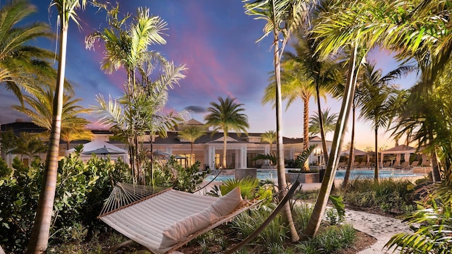 view of pool at dusk