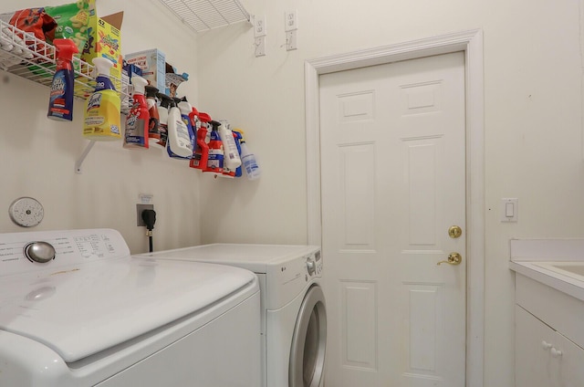 laundry area with cabinets and washing machine and dryer