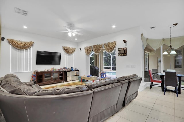 living room with ceiling fan and light tile patterned floors