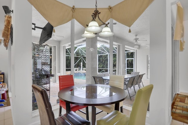 dining area featuring ceiling fan, tile patterned floors, and lofted ceiling