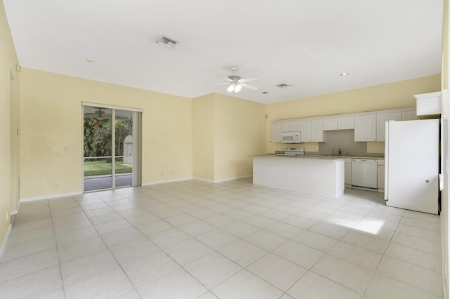 kitchen featuring a center island, white appliances, white cabinetry, light tile patterned floors, and ceiling fan