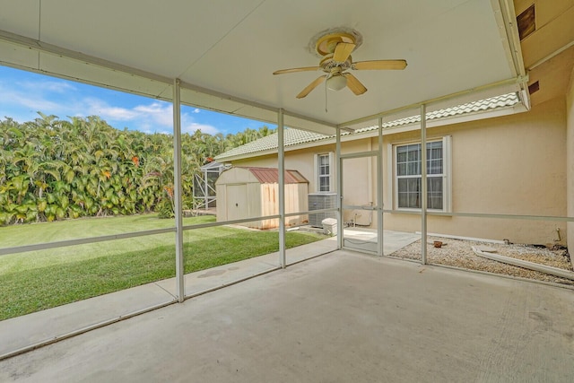 unfurnished sunroom featuring ceiling fan