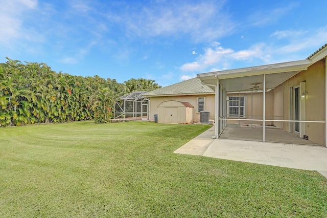 view of yard with a patio area, a storage shed, and ceiling fan