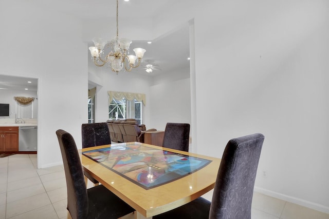 tiled dining space with ceiling fan with notable chandelier