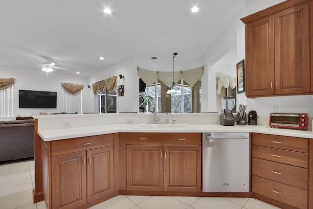 kitchen featuring dishwasher, hanging light fixtures, light tile patterned floors, sink, and ceiling fan