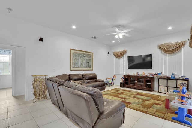 living room with ceiling fan and light tile patterned floors