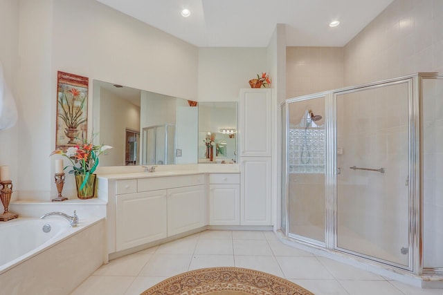 bathroom featuring tile patterned floors, vanity, and separate shower and tub