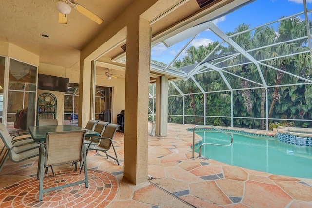 view of swimming pool with ceiling fan, a patio area, and a lanai