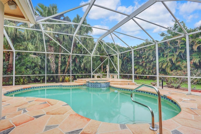 view of swimming pool with an in ground hot tub, a lanai, and a patio area