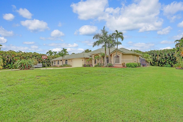 ranch-style house with a garage and a front lawn