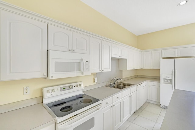 kitchen with sink, white appliances, white cabinets, and light tile patterned floors