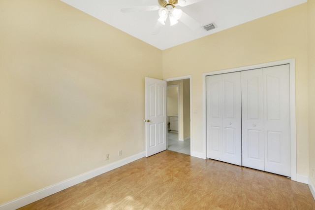 unfurnished bedroom featuring a closet, ceiling fan, and light wood-type flooring