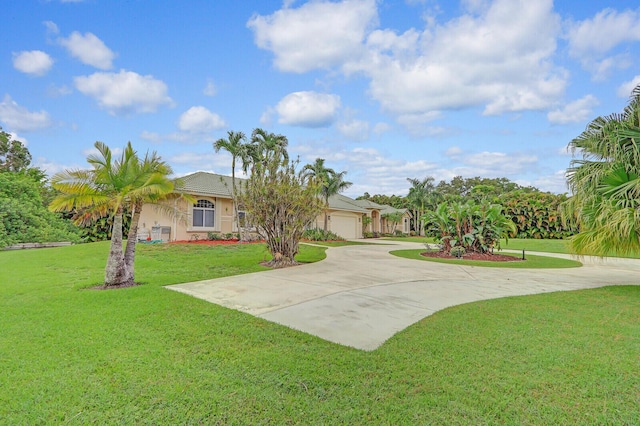 view of front of property featuring a garage and a front yard