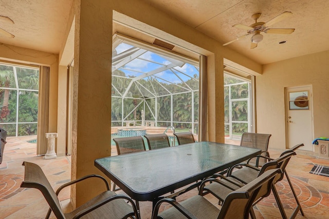 interior space with ceiling fan and glass enclosure