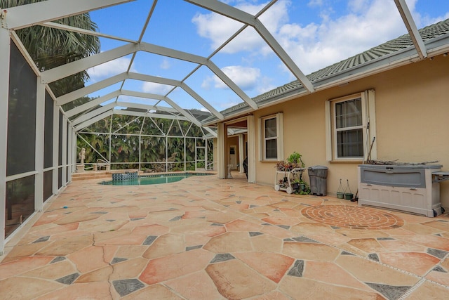 view of swimming pool with glass enclosure and a patio area