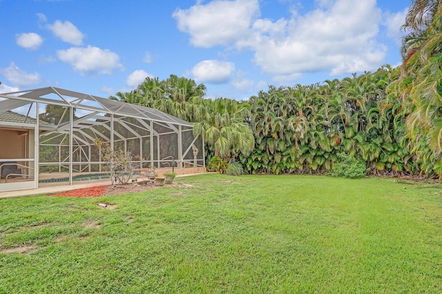 view of yard featuring glass enclosure