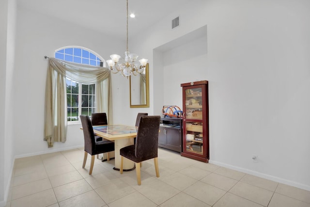 tiled dining room with a chandelier