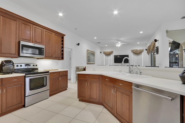 kitchen featuring sink, stainless steel appliances, ceiling fan, and light tile patterned floors