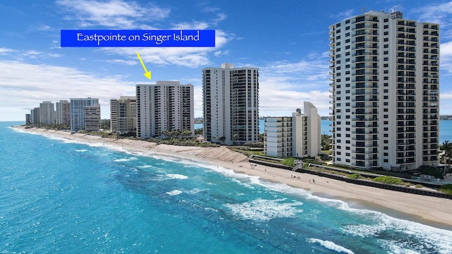 aerial view with a water view and a beach view