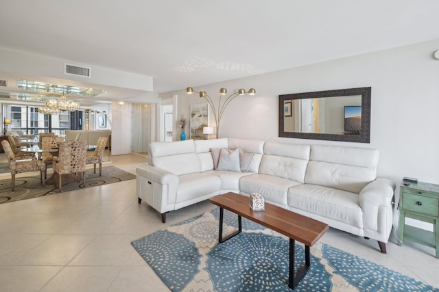 living room featuring a chandelier and tile patterned floors