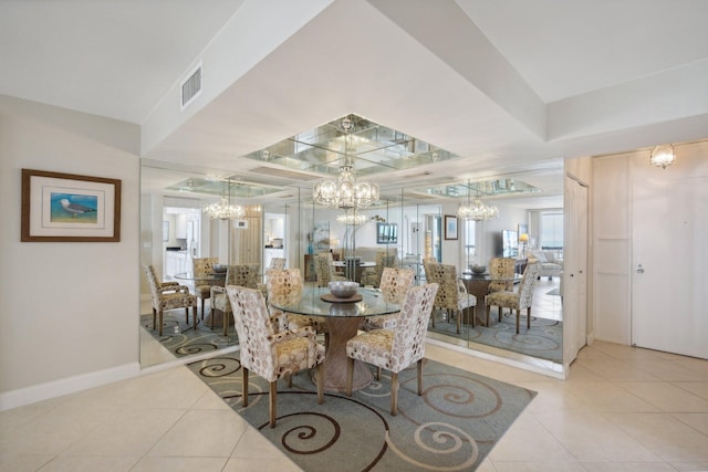 tiled dining space featuring a chandelier