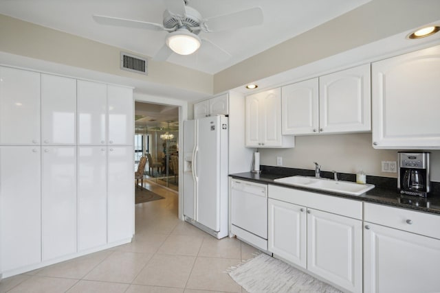 kitchen with light tile patterned flooring, white cabinetry, white appliances, ceiling fan, and sink