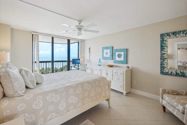 tiled bedroom with access to exterior, expansive windows, and ceiling fan