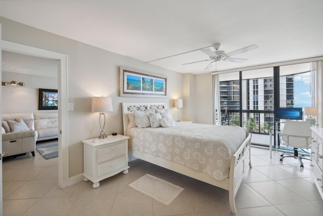 bedroom with expansive windows, access to outside, light tile patterned floors, and ceiling fan