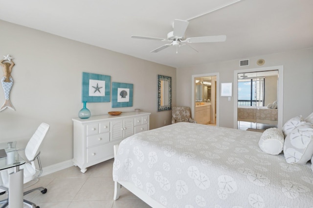 tiled bedroom featuring connected bathroom and ceiling fan