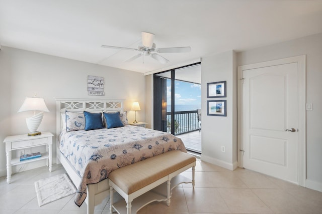 tiled bedroom with a wall of windows, access to outside, and ceiling fan