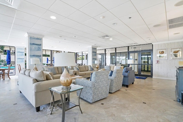 living room featuring expansive windows, french doors, and light tile patterned floors