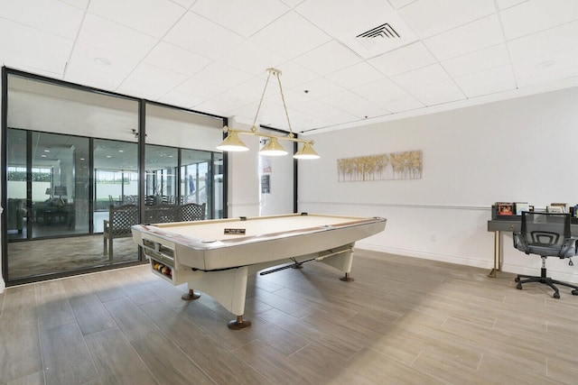 game room featuring expansive windows, hardwood / wood-style flooring, and billiards