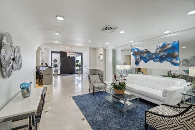 living room featuring tile patterned flooring and ornate columns