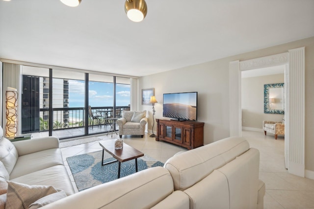 living room featuring expansive windows and light tile patterned floors