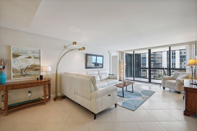 living room featuring tile patterned flooring and a wall of windows