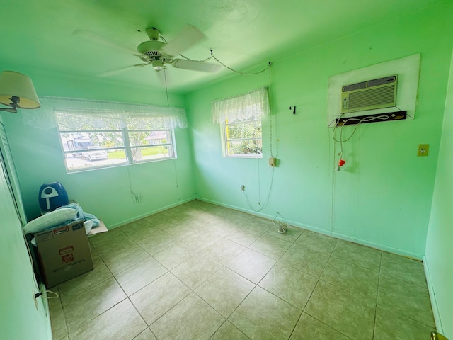 tiled spare room featuring ceiling fan and an AC wall unit