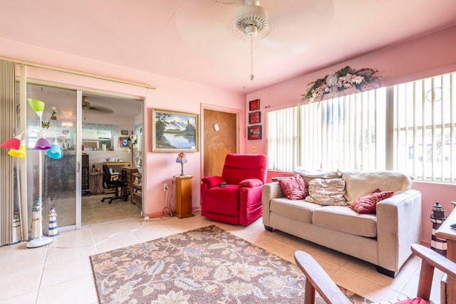 living room featuring plenty of natural light, light tile patterned floors, and ceiling fan