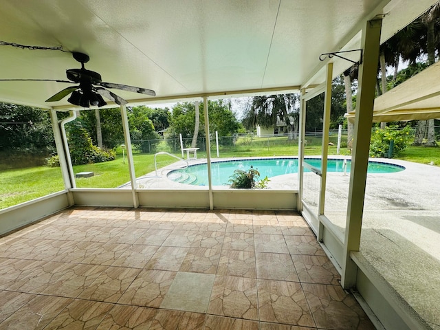 view of pool featuring a patio area, a lawn, and ceiling fan