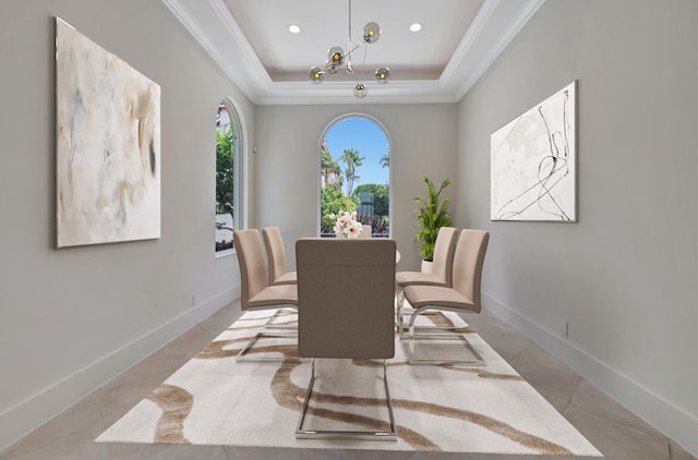 dining area with a raised ceiling and light tile patterned floors