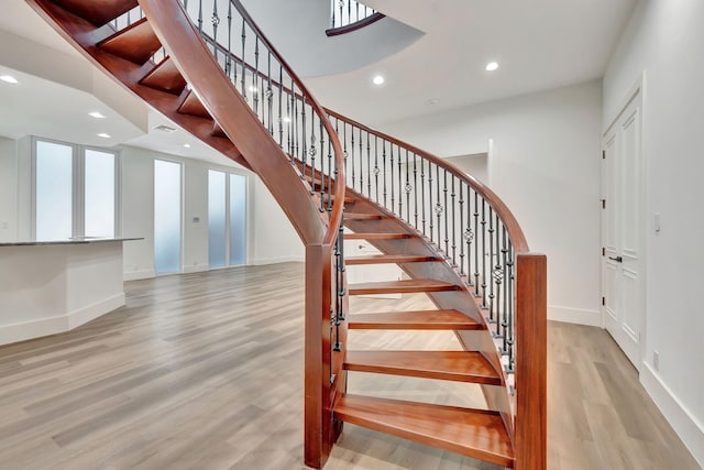 staircase with hardwood / wood-style flooring