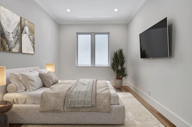 bedroom with wood-type flooring and ornamental molding