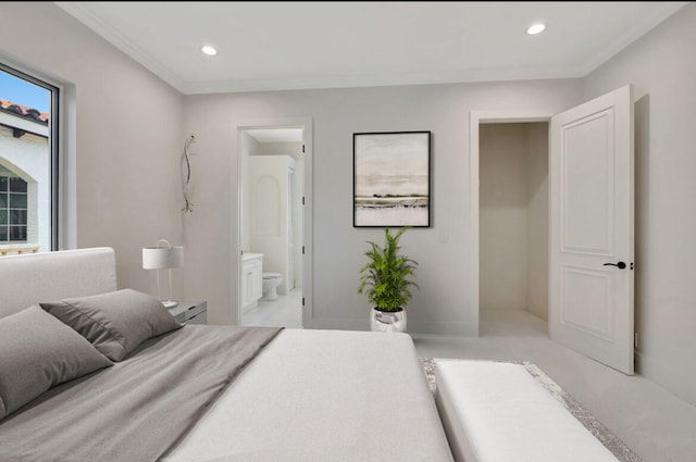 carpeted bedroom with ensuite bath and crown molding