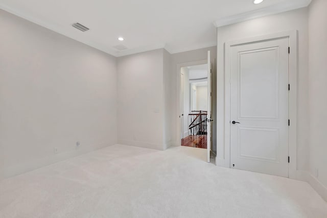 unfurnished room with ornamental molding and carpet flooring