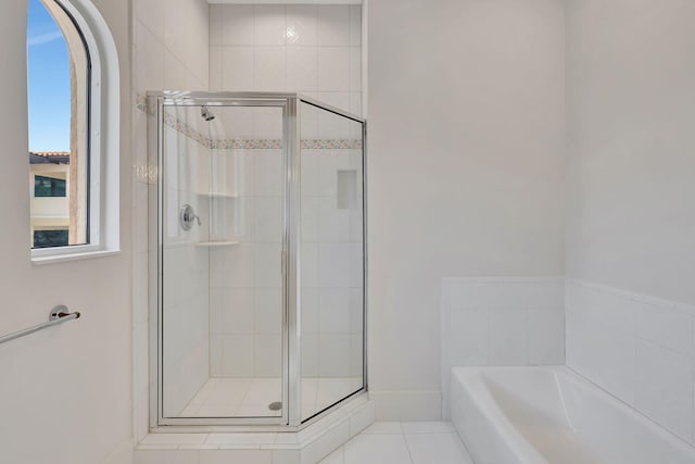 bathroom featuring independent shower and bath and tile patterned floors