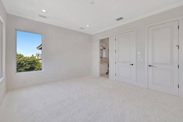 unfurnished bedroom with light carpet, connected bathroom, and ornamental molding