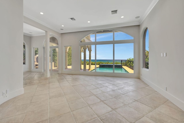 unfurnished living room featuring ornamental molding and a water view