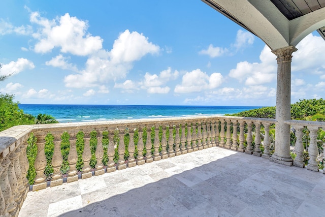 view of patio with a balcony and a water view